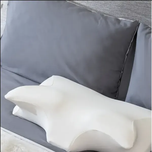 Maas & Bath Ergo Pillow on a bed
